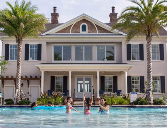 Happy family playing in the Pool at the Manor House at Markland | Amenities at the Markland Home Community in St. Augustine, Florida.